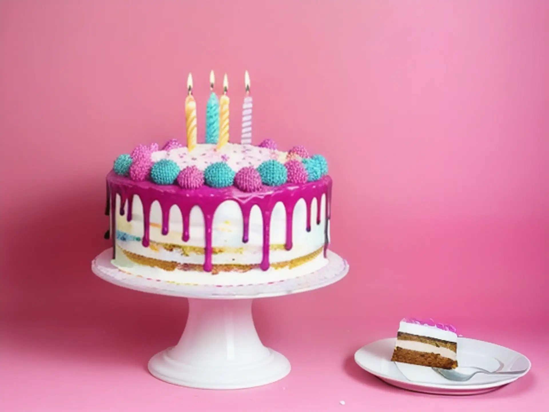 Feestelijke dripcake met roze glazuur en verjaardagskaarsen